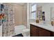 Well-lit bathroom with a shower-tub combo, vanity, and a coordinated animal-themed shower curtain at 17019 Seville Orange Rd, Winter Garden, FL 34787