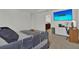 Inviting bedroom featuring a comfortable bed, desk area, and modern décor at 17019 Seville Orange Rd, Winter Garden, FL 34787