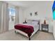 This cozy bedroom features neutral walls, a plush bed, and a bright window for ample natural light at 17019 Seville Orange Rd, Winter Garden, FL 34787
