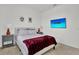 A well-lit bedroom with a mounted TV, complemented by stylish decor and comfortable furnishings at 17019 Seville Orange Rd, Winter Garden, FL 34787
