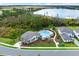 Aerial shot showcasing the community pool with lounge area, lush landscaping, and adjacent houses at 17019 Seville Orange Rd, Winter Garden, FL 34787