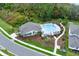 Aerial view of the community pool, featuring lounge chairs, tables, and lush landscaping at 17019 Seville Orange Rd, Winter Garden, FL 34787