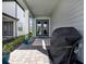 Covered front porch features double glass doors, a patterned rug, and a grill at 17019 Seville Orange Rd, Winter Garden, FL 34787