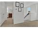 Hallway with Gathering photo display, leading to a bathroom at 17019 Seville Orange Rd, Winter Garden, FL 34787