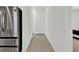 Hallway view showing the stainless steel refrigerator and door entrance at 17019 Seville Orange Rd, Winter Garden, FL 34787