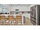 Bright, spacious kitchen with white cabinets, stainless steel appliances, and quartz countertops at 17019 Seville Orange Rd, Winter Garden, FL 34787