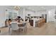 Open kitchen with a large island, pendant lighting, and stainless steel appliances at 17019 Seville Orange Rd, Winter Garden, FL 34787