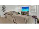 Spacious living room with a large sectional sofa and modern entertainment center at 17019 Seville Orange Rd, Winter Garden, FL 34787