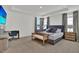 Spacious main bedroom with a sitting area, desk, and large windows for abundant natural light at 17019 Seville Orange Rd, Winter Garden, FL 34787