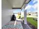 Inviting porch with a patterned rug, neutral siding, and a glimpse of the neighborhood at 17019 Seville Orange Rd, Winter Garden, FL 34787