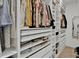 Organized walk-in closet with ample shelving, drawers, and storage for clothes and accessories at 17019 Seville Orange Rd, Winter Garden, FL 34787