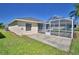 A covered, screened-in back porch area with concrete flooring, perfect for outdoor relaxation at 1010 High Vista Dr, Davenport, FL 33837