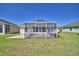 A screened-in lanai at the rear of the home provides a bug-free outdoor living space and beautiful backyard views at 1010 High Vista Dr, Davenport, FL 33837