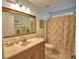 Well-lit bathroom with vanity, mirror, and tiled floors at 1010 High Vista Dr, Davenport, FL 33837