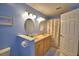 Bathroom with double sinks, and shower featuring a decorative floral curtain and a bright blue paint at 1010 High Vista Dr, Davenport, FL 33837