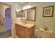 Bathroom showcasing vanity, toilet, lighting, and mirror at 1010 High Vista Dr, Davenport, FL 33837