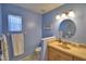 Bathroom featuring a vanity with ample storage, single sink, and decorative oval mirror at 1010 High Vista Dr, Davenport, FL 33837