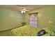 Bright bedroom with shelves, window, ceiling fan, and comfortable bed at 1010 High Vista Dr, Davenport, FL 33837