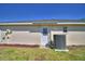 A clean white door offers access to the home's exterior, complete with a modern A/C unit on green grass at 1010 High Vista Dr, Davenport, FL 33837