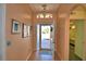 Warm and inviting foyer with tile flooring, arched doorway, and an elegant light fixture at 1010 High Vista Dr, Davenport, FL 33837