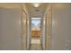 Hallway view with closet space leading to ensuite bathroom with double sinks and ample cabinet space at 1010 High Vista Dr, Davenport, FL 33837