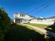 Exterior shot showcasing a well-manicured lawn, string lights, and a charming two-story home at 1024 Prosperity Dr, Winter Garden, FL 34787