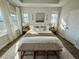 Bright main bedroom featuring a woven bench, natural lighting, and calm neutral decor at 1024 Prosperity Dr, Winter Garden, FL 34787