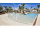 Beautiful community pool featuring a zero entry point, palm trees, and lounge chairs at 1024 Prosperity Dr, Winter Garden, FL 34787