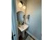 Compact powder room with modern sink, round mirror, and contemporary lighting at 1024 Prosperity Dr, Winter Garden, FL 34787