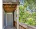 Balcony overlooking lush greenery with wooden railings and a sliding door for easy access at 110 Scottsdale Sq # 110, Winter Park, FL 32792