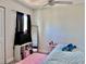 Cozy bedroom with a ceiling fan, pink rug, natural light from the window, and simple decor at 110 Scottsdale Sq # 110, Winter Park, FL 32792