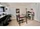 Bright dining area with stylish decor, a glass-top table, and a view into the modern kitchen at 110 Scottsdale Sq # 110, Winter Park, FL 32792