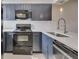 Modern kitchen featuring sleek appliances, stylish cabinets, and quartz countertops at 110 Scottsdale Sq # 110, Winter Park, FL 32792