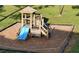 Community playground with slide and play structure surrounded by protective borders at 110 Scottsdale Sq # 110, Winter Park, FL 32792