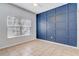 Bedroom with a blue accent wall and large window that allows for natural light at 13046 Island Breeze Ct, Orlando, FL 32824