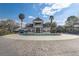 Community pool surrounded by seating and palm trees at 13046 Island Breeze Ct, Orlando, FL 32824