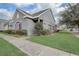 Charming home exterior featuring gray stucco, blue shutters, and well-maintained landscaping in a residential neighborhood at 13046 Island Breeze Ct, Orlando, FL 32824