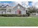 Charming home exterior featuring gray stucco, blue shutters, and well-maintained landscaping in a residential neighborhood at 13046 Island Breeze Ct, Orlando, FL 32824