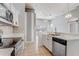 Well-lit kitchen featuring white cabinetry, stainless steel appliances, and open access to the living area at 13046 Island Breeze Ct, Orlando, FL 32824