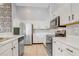 Modern kitchen featuring white cabinets, stainless steel appliances, and tile flooring for a clean, bright design at 13046 Island Breeze Ct, Orlando, FL 32824