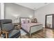 Comfortable bedroom features wood floors, a plush bed with pink pillows, and a decorative mirror at 13333 Beebe Aly, Orlando, FL 32827