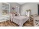 Bright bedroom features a comfortable bed, side tables, and natural light with a decorative full length mirror at 13333 Beebe Aly, Orlando, FL 32827