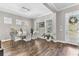 Bright dining room featuring wood floors, a glass table with seating for six, and ample natural light at 13333 Beebe Aly, Orlando, FL 32827