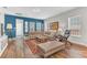 Cozy living room featuring a sectional sofa, wood floors, natural light, and stylish decor at 13333 Beebe Aly, Orlando, FL 32827