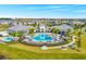 Aerial view of a community pool, splash pad, clubhouse, and tennis courts at 13348 Panama Beach Ct, Orlando, FL 32827