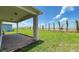 Covered patio with brick pavers overlooks the spacious, well-manicured lawn at 13348 Panama Beach Ct, Orlando, FL 32827