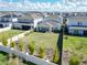 Aerial view of backyard with manicured lawn, privacy fence, and mature landscaping at 13348 Panama Beach Ct, Orlando, FL 32827