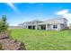 Expansive backyard features lush green grass, a patio and a privacy fence at 13348 Panama Beach Ct, Orlando, FL 32827