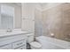 Bathroom showcasing a vanity, toilet and tiled shower-tub combination at 13348 Panama Beach Ct, Orlando, FL 32827