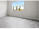 Bright bedroom featuring wood-look floors and a large window offering natural light at 13348 Panama Beach Ct, Orlando, FL 32827
